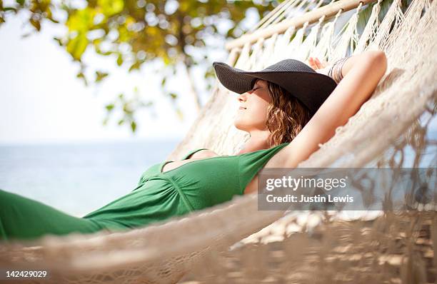 girl resting on hammock by the beach - hammock fotografías e imágenes de stock