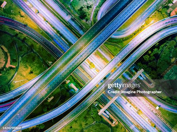 aerial top view, highway road, bridge over main road at night for transportation that facilitates the travel of car users on the road transportation or futuristic concept. - car aerial view stock pictures, royalty-free photos & images