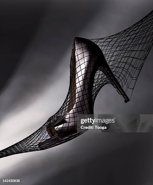 high heels inside black fishnet stockings - fishnet stockings stock pictures, royalty-free photos & images
