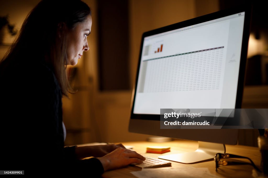 Serious woman working late at home