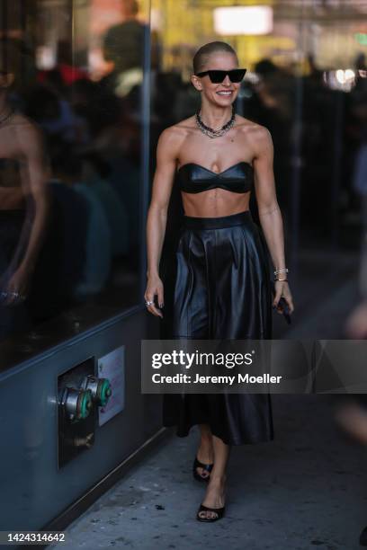 Caro Daur seen wearing a black leather bralette, a black leather skirt, Tiffany & Co City HardWeare silver chain necklace and black Celine sunglasses...