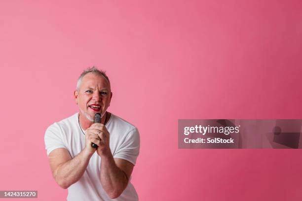 singing into a brush - man pink stock pictures, royalty-free photos & images