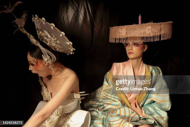 Models prepare backstage before the MAOGEPING Beauty show by Chinese designer Mao Geping during the day two of Beijing Fashion Week at Wangfujing...