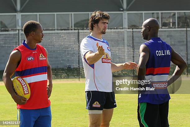 Jamaican 4 x 100m relay world record holder Michael Frater and Saint Kitts and Nevis sprinter Kim Collins meet with Western Bulldogs' AFL player...