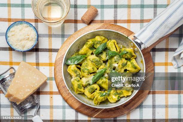 tortellini in pesto sauce - tortellini stock pictures, royalty-free photos & images