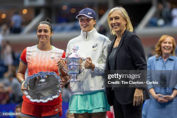 September 10: Iga Swiatek of Poland with the winner's trophy presented by Martina Navratilova and Ons Jabeur of Tunisia with the runners-up trophy...