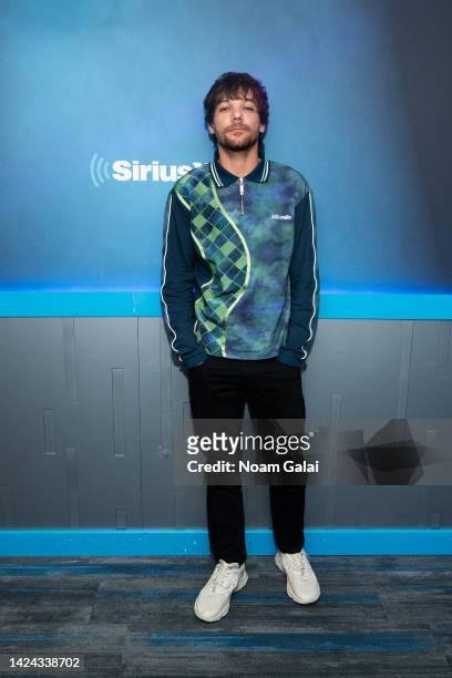 Louis Tomlinson visits 'Hits 1' with Nicole Ryan and Ryan Sampson at the SiriusXM Studios on September 16, 2022 in New York City.