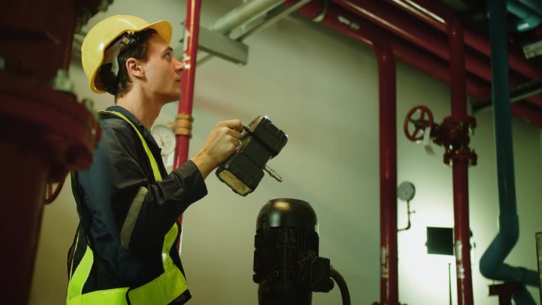 Professional engineer worker man in safety uniform holding flashlight ...
