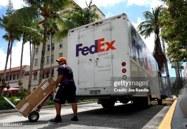 FedEx worker makes a delivery on September 16, 2022 in Miami Beach, Florida. Shares of FedEx fell after the company missed estimates on revenue and...