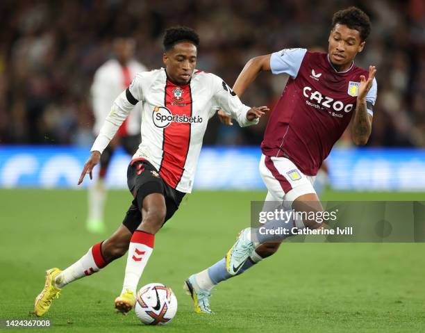 Kyle Walker-Peters of Southampton runs with the ball whilst under pressure from Boubacar Kamara of Aston Villa during the Premier League match...