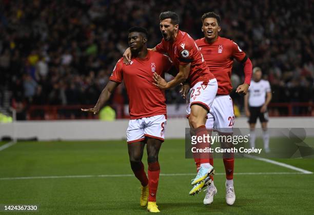 Taiwo Awoniyi of Nottingham Forest celebrates with teammates Remo Freuler and Brennan Johnson after scoring their team's first goal during the...