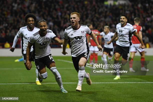 Harrison Reed of Fulham celebrates with teammates Bobby Reid and Willian after scoring their team's third goal during the Premier League match...