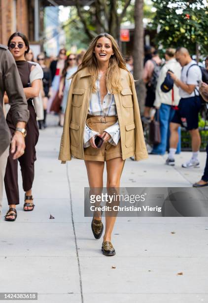 Olivia Palermo wearing beige jacket, shorts, striped button shirt, loafers outside Jonathan Simkhai on September 13, 2022 in New York City.