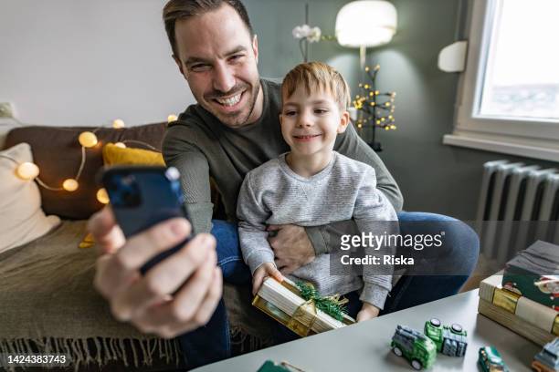 family of two taking a selfie during new year's day - 2 5 months stock pictures, royalty-free photos & images