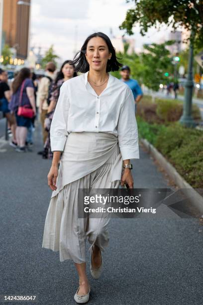 Eva Chen wearing white button shirt, pleated skirt outside Tory Burch on September 13, 2022 in New York City.