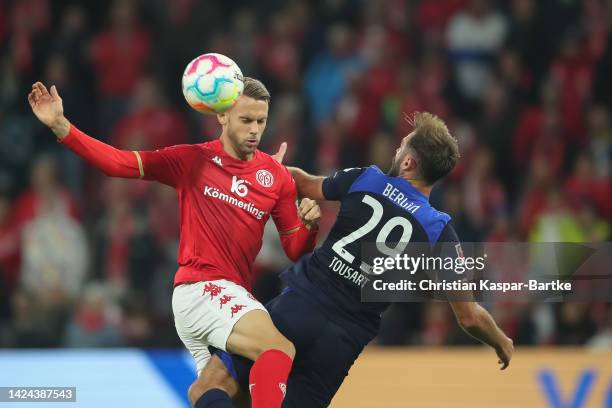 Lucas Toussart of Hertha BSC is tackled by Marcus Ingvartsen of 1. FSV Mainz 05 during the Bundesliga match between 1. FSV Mainz 05 and Hertha BSC at...