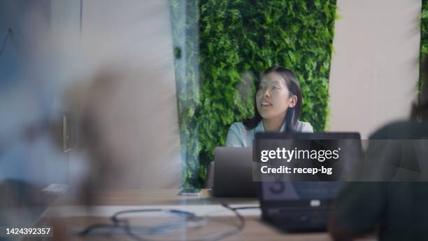 young businesswoman attending business meeting in meeting room in modern office working space - esg stock pictures, royalty-free photos & images