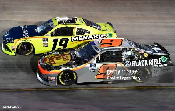 Noah Gragson, driver of the Bass Pro Shops/TrueTimber/BRCC Chevrolet, and Brandon Jones, driver of the Menards/Jeld-Wen Toyota, race during the...