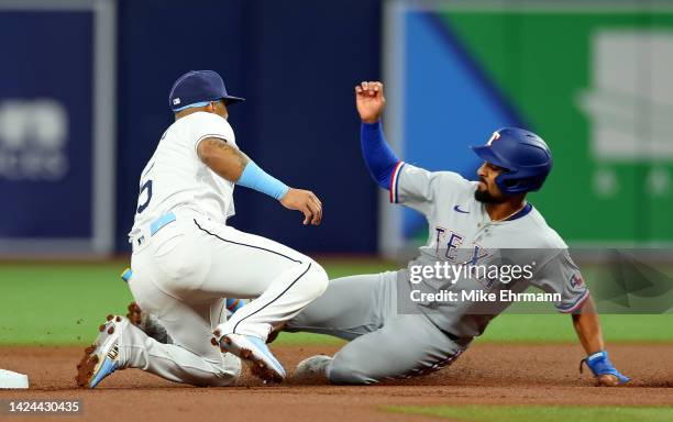 Marcus Semien of the Texas Rangers is caught stealing by Wander Franco of the Tampa Bay Rays in the first inning during a game at Tropicana Field on...