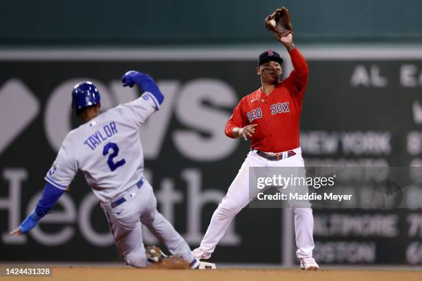 Rafael Devers of the Boston Red Sox throws to first after forcing out Michael A. Taylor of the Kansas City Royals during the seventh inning at Fenway...