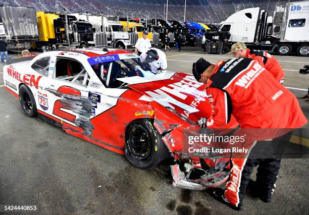 Crew members attend the Whelen Chevrolet, driven by Sheldon Creed in the garage area after an on-track incident during the NASCAR Xfinity Series Food...