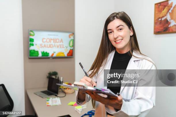 portrait of nutritionist in her office - nutritionist stock pictures, royalty-free photos & images