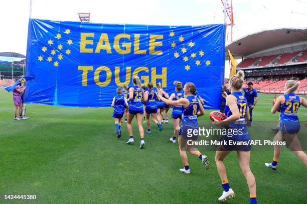 West Coast head out to their banner during the round four AFLW match between the Greater Western Sydney Giants and the West Coast Eagles at GIANTS...