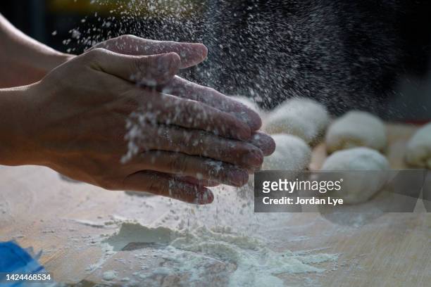 chef clapping with flour in hand - back to work stock-fotos und bilder