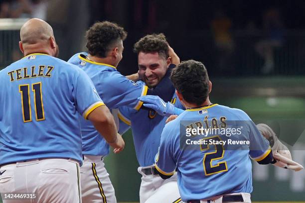 Garrett Mitchell of the Milwaukee Brewers is congratulated by teammates following a game winning walk off single during the ninth inning against the...