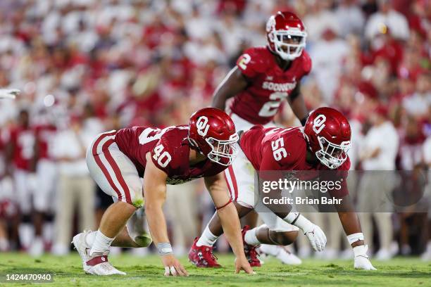 Defensive linemen Ethan Downs and Gracen Halton of the Oklahoma Sooners prepare to rush the Kent State Golden Flashes in the fourth quarter at...