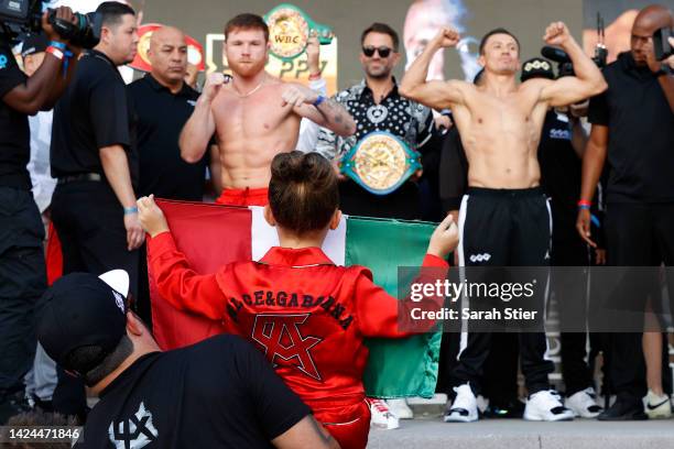 Canelo Alvarez of Mexico and Gennadiy Golovkin of Kazakhstan pose as Alvarez's daughter, Maria Fernanda Alvarez, holds the Mexican national flag...