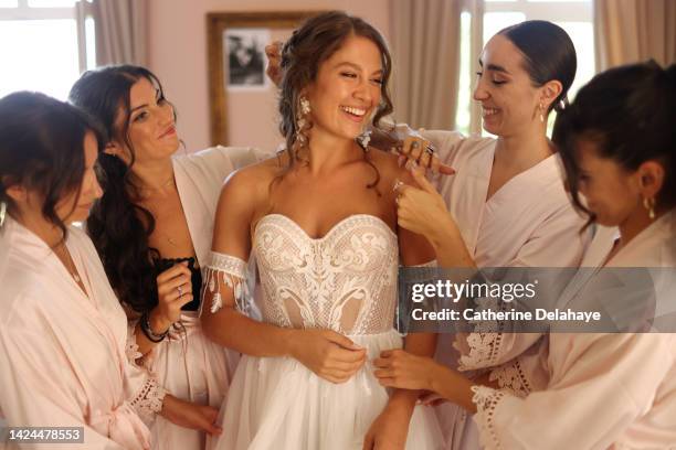 a bride getting ready with her bridesmaid before her wedding ceremony - noiva imagens e fotografias de stock