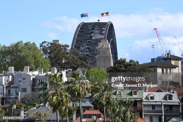 The Australian national flag and the Aboriginal flag are seen at half mast atop the Sydney Harbour Bridge as a sign of respect for the passing of...