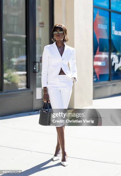 Amy Juliette Lefévre wearing white blazer, cropped pants, black bucket bag outside Michael Kors on September 14, 2022 in New York City.