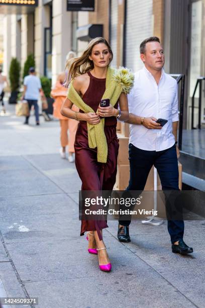 Olivia Palermo wearing silk skirt, top, pink heels outside on September 14, 2022 in New York City.