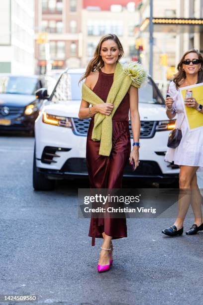 Olivia Palermo wearing silk skirt, top, pink heels outside on September 14, 2022 in New York City.