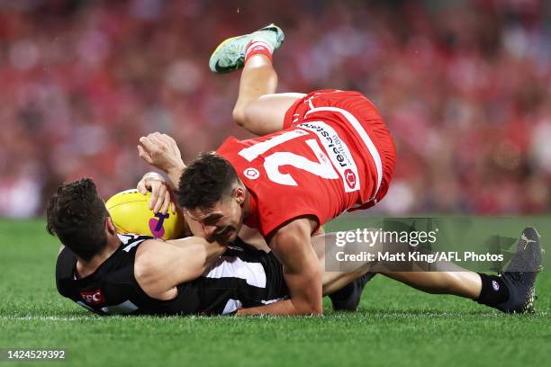 Jack Crisp of the Magpies is tackled by Errol Gulden of the Swans during the AFL Second Preliminary match between the Sydney Swans and the...
