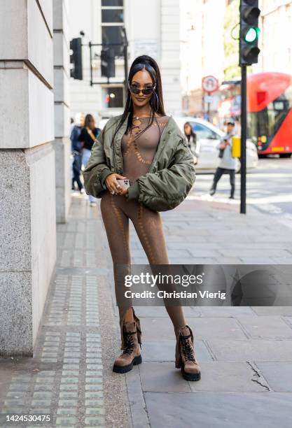 Jourdan Dunn wears green bomber jacket, brown overall outside Poster Girl during London Fashion Week September 2022 on September 16, 2022 in London,...