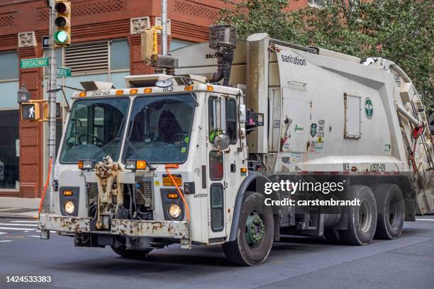 heavy garbage truck on broadway - garbage truck driving stock pictures, royalty-free photos & images