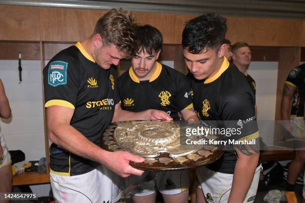 Taine Plumtree, Connor Garden-Bachop, and Keelan Whitman of Wellington celebrate with the Ranfurly Shield following the round seven Bunnings NPC...