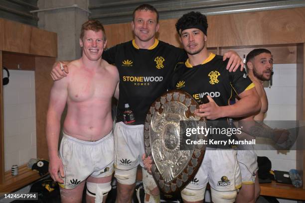 James Blackwell, Dominic Bird, and Caleb Delany of Wellington celebrate with the Ranfurly Shield following the round seven Bunnings NPC match between...