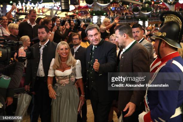 Bavarian Minister-President Markus Söder attends with his wife Karin Baumüller-Söder the opening day at Schottenhamel beer tent of the 2022...
