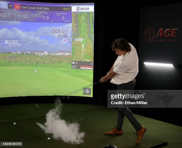 Golf ball explodes as Trevor Zegras of the Anaheim Ducks takes a swing at a golf simulator during the 2022 NHL player media tour at Encore Las Vegas...