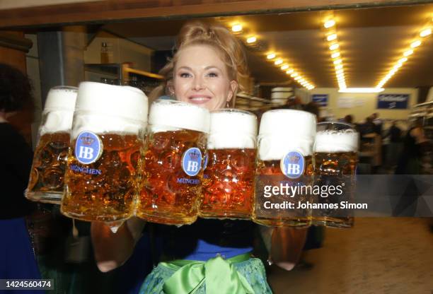 Waitress is carries some Mass of beer in the Hofbrauhaus tent on the opening day of the 2022 Oktoberfest beer fest on September 17, 2022 in Munich,...