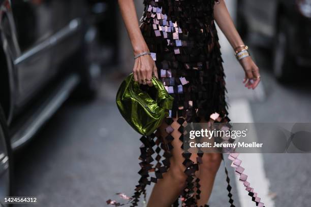 Leonie Hanne is seen wearing purple sequins pattern short dress and a green metallic Bottega Veneta bag, outside Jonathan Simkhai, during New York...