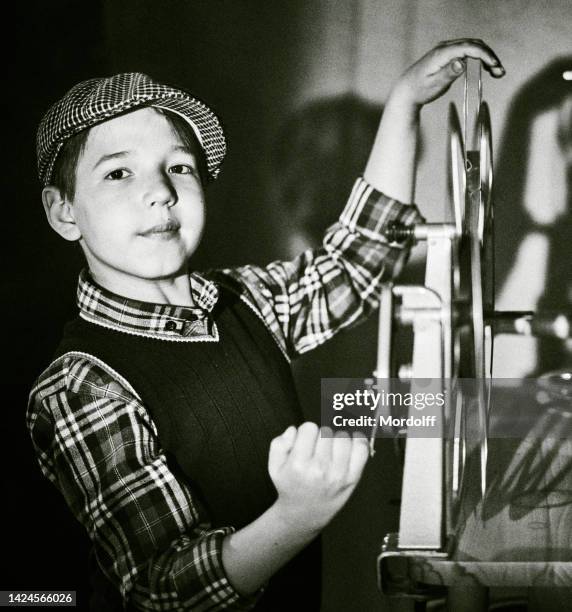 young cinema film projectionist is operating 16 mm film projector - cinema projector stock pictures, royalty-free photos & images