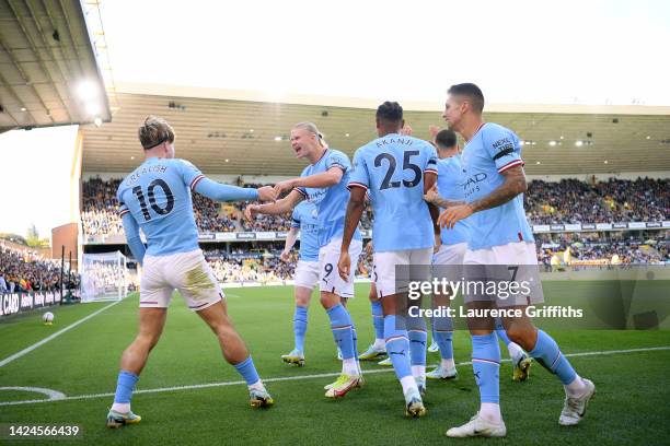 Jack Grealish of Manchester City celebrates with Erling Haaland after scoring their side's first goal during the Premier League match between...