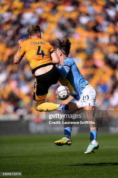 Jack Grealish of Manchester City is fouled by Nathan Collins of Wolverhampton Wanderers leading to a red card during the Premier League match between...