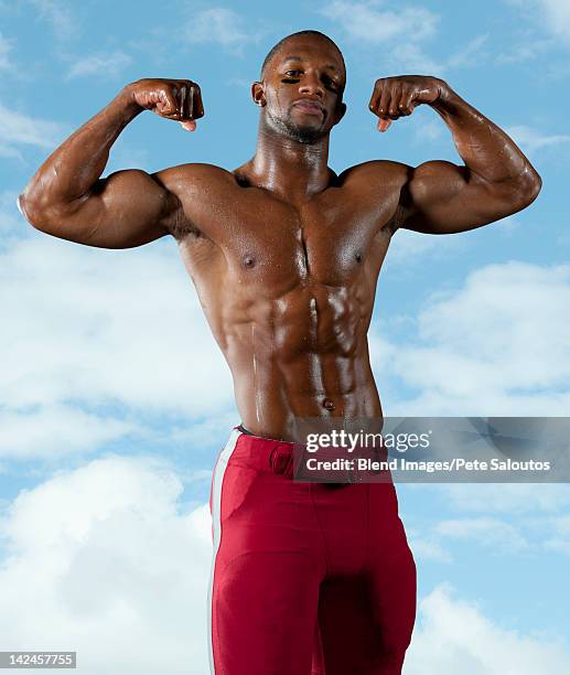 black football player flexing muscles - black male bodybuilders stock pictures, royalty-free photos & images