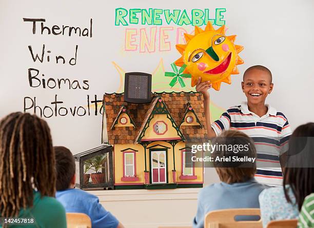 boy talking about renewable energy in school - boy in briefs stock pictures, royalty-free photos & images